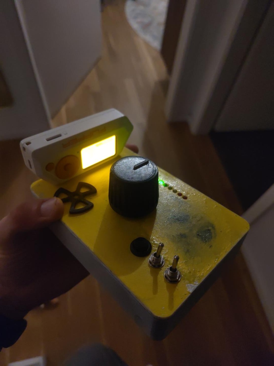 The physical reactor console: a mounted Flipper Zero, large knob, button, switches and ten LEDs