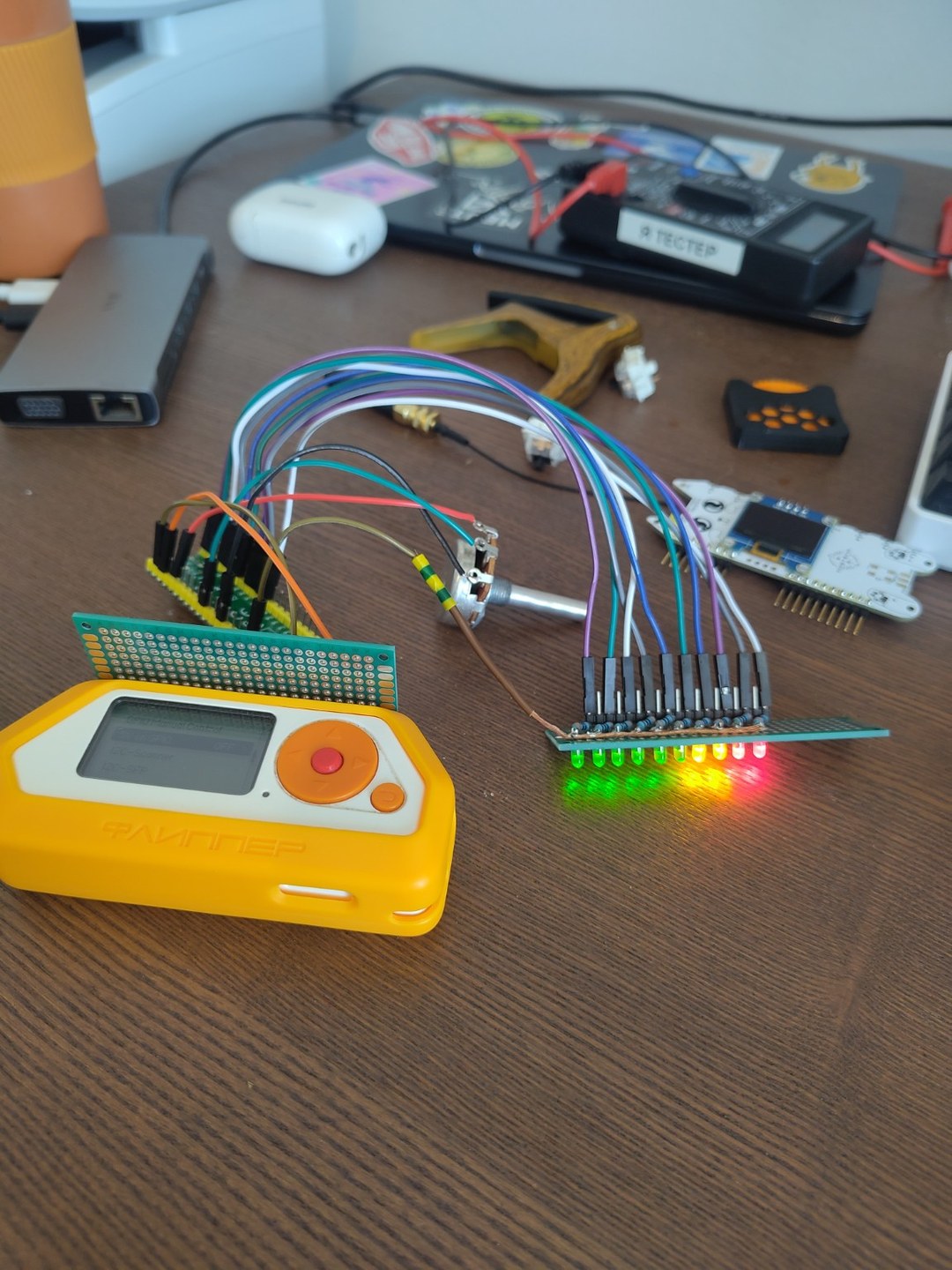 Early working prototype with Flipper Zero, potentiometer, Pico and illuminated LED bar connected by loose wires